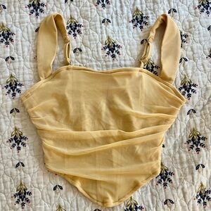 Adorable ruffled yellow corset top.